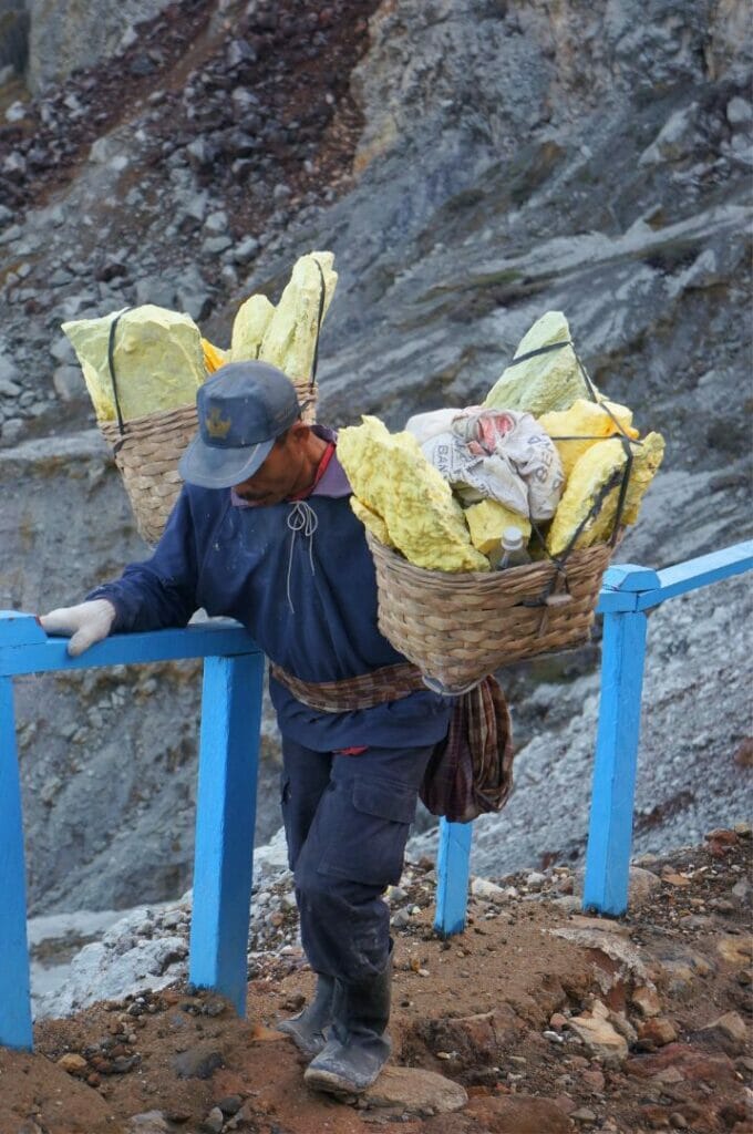 a sulfur miner coming up from the crater of the Ijen volcano in Indonesia