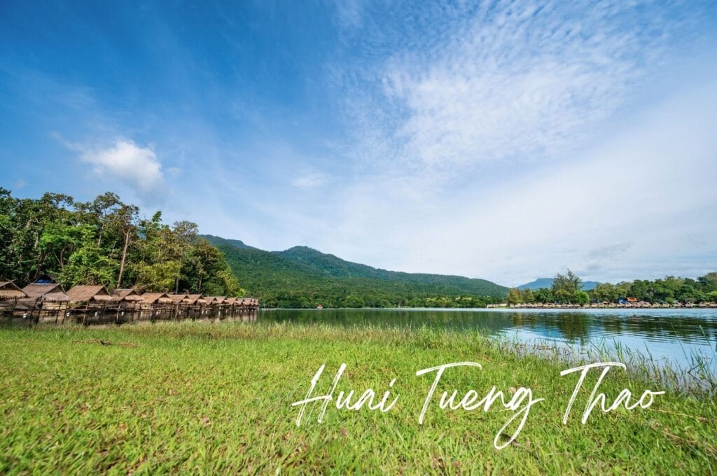 small straw huts on stilts around Lake Huai Tueng Thao