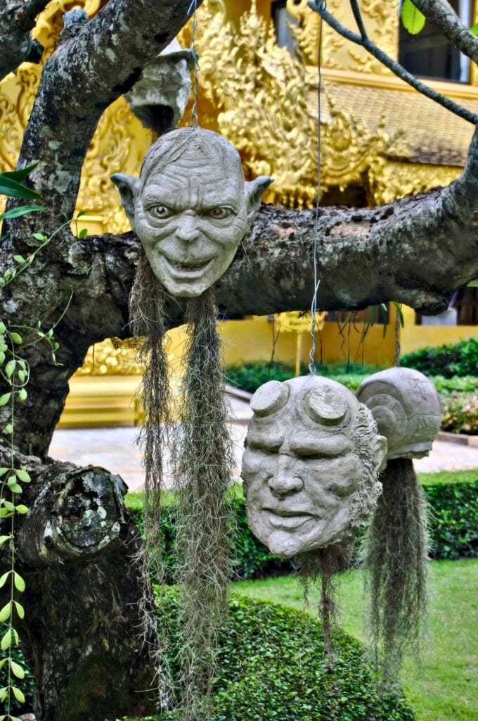sculptures de têtes accrochées à un arbre