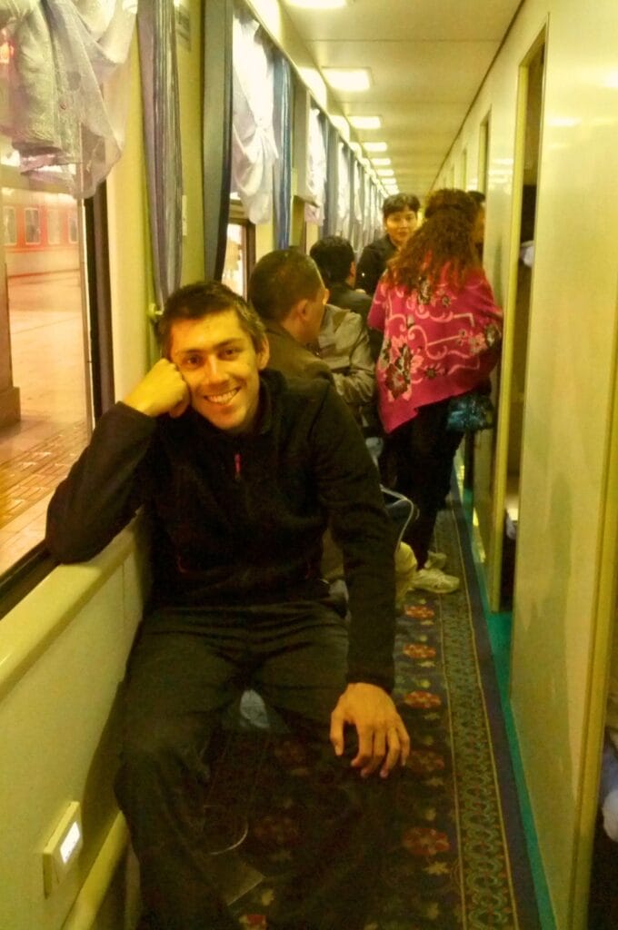 Benoit assis dans un couloir d'un train