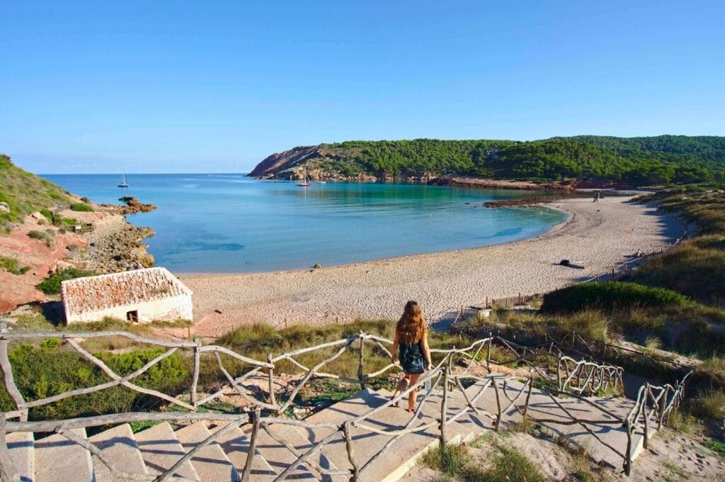 Fabienne walking down the steps toward Algaiarens Beach