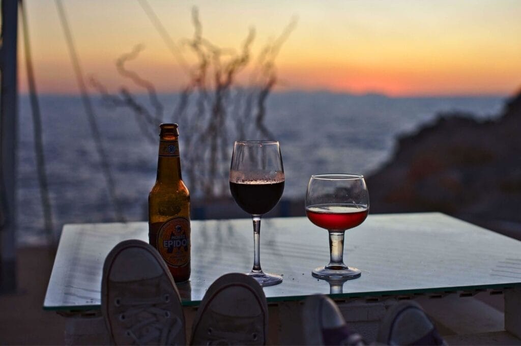 drinks at a bar overlooking the sunset over the Mediterranean